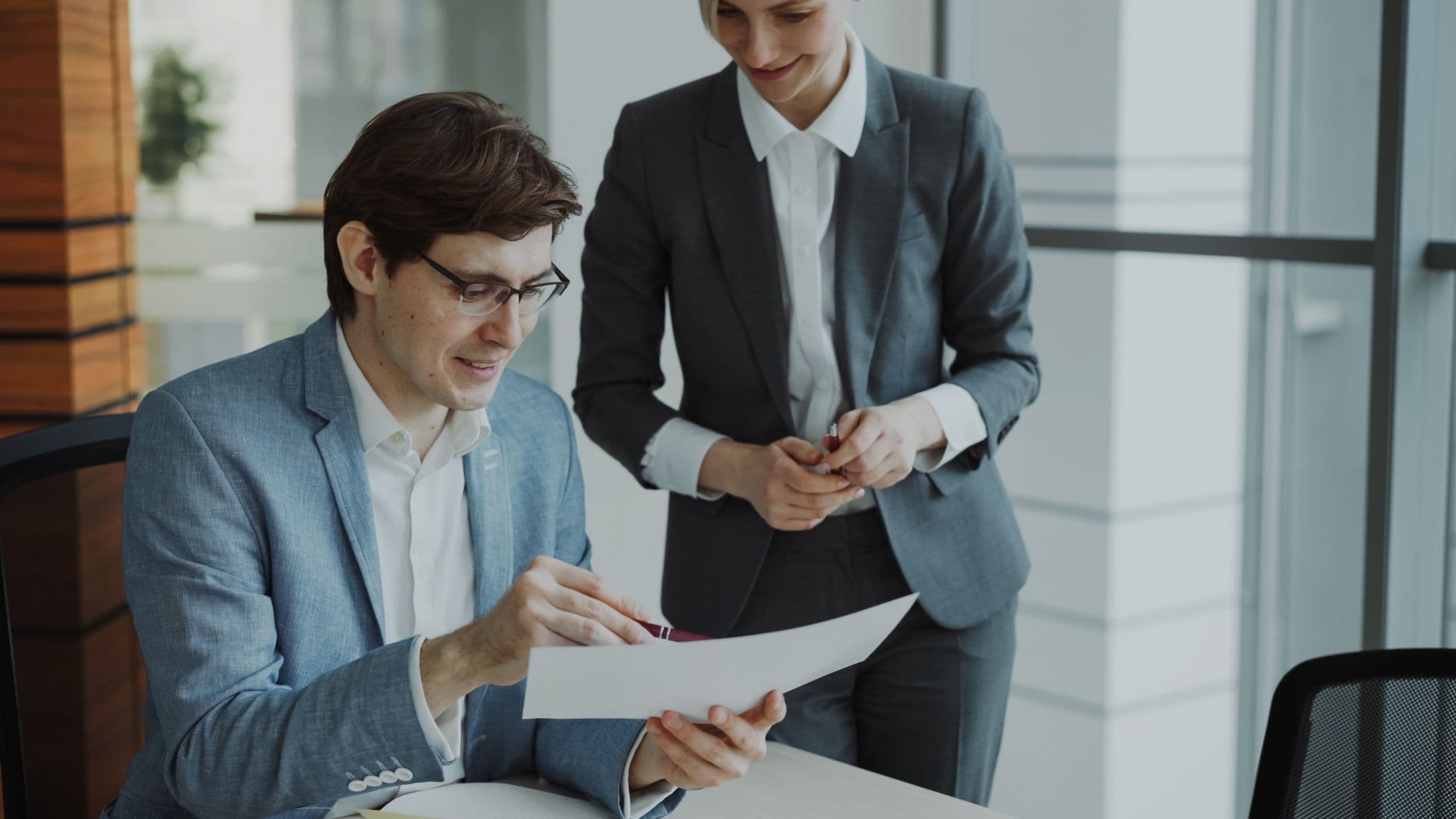 Two advisors going through a client’s paperwork together